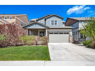 Charming two-story home with a well-manicured lawn, inviting curb appeal, and a two-car garage at 476 Hyde Park Cir, Castle Pines, CO 80108