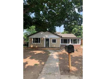 Charming single-story home with fresh exterior paint, updated windows, and a walkway leading to the front door at 3530 Chase St. St, Wheat Ridge, CO 80212
