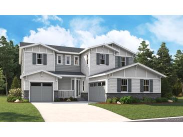 New two-story home with a three-car garage, gray siding, and gray shutters at 5622 Riverbend Ave, Firestone, CO 80504