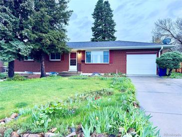 Charming brick home with a well-manicured front yard and mature trees, plus an attached garage at 12046 W Green Mountain Dr, Lakewood, CO 80228