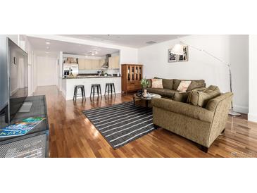 Comfortable living room with open floor plan, breakfast bar, hardwood floors and stylish decor at 1560 Blake St # 810, Denver, CO 80202