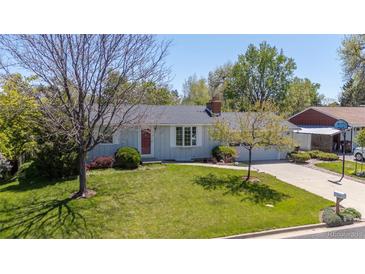 Charming ranch-style home with a well-manicured lawn, mature trees, and a cozy, inviting atmosphere at 1322 Wicklow St, Boulder, CO 80303