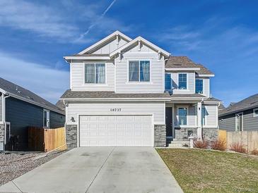 Charming two-story home featuring a well-manicured lawn and an attached two-car garage at 16737 Lake Helen Blvd, Mead, CO 80542