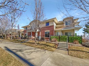 Attractive brick townhouse with a landscaped front yard and walkway at 7440 Lowell Blvd # B, Westminster, CO 80030