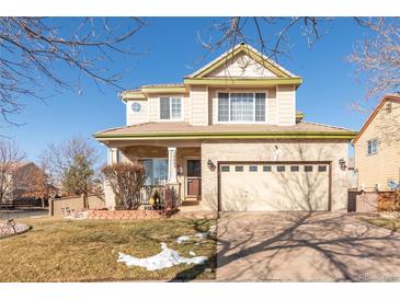Two-story house with attached garage and landscaping at 19805 E 58Th Pl, Aurora, CO 80019