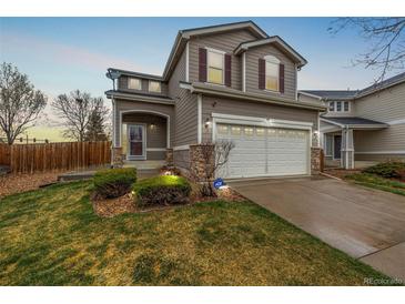 Charming two-story home featuring a well-manicured lawn and attached two-car garage at 5171 E 119Th Ct, Thornton, CO 80233