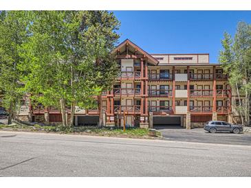 Attractive condo building with wood beam accents and private balconies, nestled among mature trees at 815 Columbine Rd # 22, Breckenridge, CO 80424