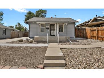 Charming single-story home features a covered porch, landscaped front yard, and inviting curb appeal at 127 S Perry St, Denver, CO 80219