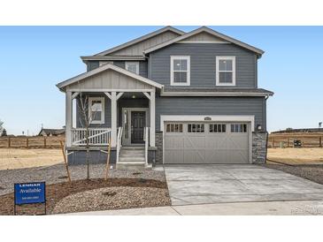 Charming two-story home with a welcoming porch, attached two-car garage, and professionally landscaped front yard at 11052 Snowdon St, Parker, CO 80134