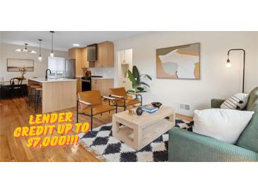 Bright living room featuring hardwood floors, modern furnishings, and an open layout connecting to the kitchen at 2814 N Harrison St, Denver, CO 80205