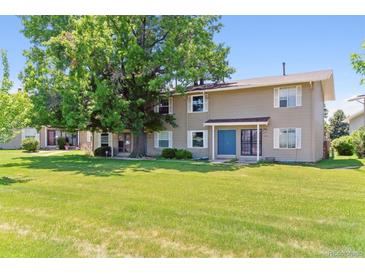 Charming townhome with a well-manicured lawn and a large shade tree in a quiet neighborhood at 1927 S Peoria St, Aurora, CO 80014