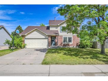 Charming two-story home with a well-manicured lawn, driveway, and attached two-car garage at 9946 Harrison St, Thornton, CO 80229