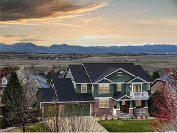 Charming two-story home with attached garage, front porch, and mountain views at 1348 Lawson Ave, Erie, CO 80516
