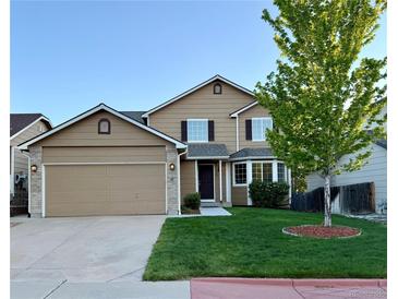 Charming two-story home with a well-maintained lawn and attached two-car garage at 23760 Broadmoor Dr, Parker, CO 80138