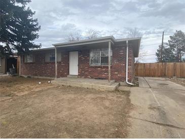 Charming brick home featuring a covered entryway and a spacious driveway at 12801 Randolph Pl, Denver, CO 80239