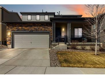 Charming two-story home with stone accents, covered porch, and well-maintained landscaping at 12759 Buffington Trl, Parker, CO 80134