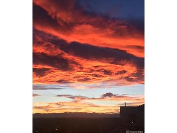 Scenic sunset view featuring vibrant, colorful clouds and a glimpse of the horizon at 5726 N Genoa Way # 301, Aurora, CO 80019