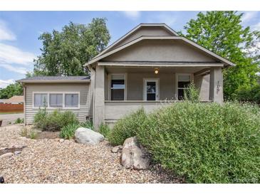 Charming single-story home with a covered porch and rock garden in the front yard at 109 W Simpson St, Lafayette, CO 80026