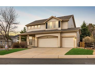Charming two-story home with a two-car garage and a beautifully maintained lawn at 7661 Chickaree Ct, Littleton, CO 80125