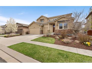 Charming two-story home with a three-car garage, stone accents and well-manicured front yard at 15980 Pikes Peak Dr, Broomfield, CO 80023
