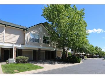 Townhome with attached garage, manicured lawn and lush tree at 1652 Egret Way, Superior, CO 80027