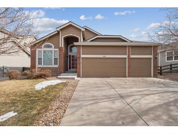 Charming, well-maintained home featuring a three-car garage and a manicured front lawn at 7496 Chipmunk Pl, Littleton, CO 80125