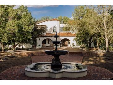 Stunning front yard with a classic fountain and grand Spanish-style home featuring a red tile roof at 3 Carriage Brook Rd, Cherry Hills Village, CO 80121
