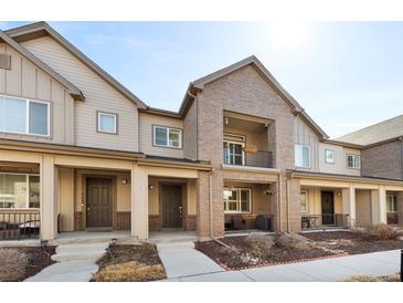 Attractive townhome showcasing a well-maintained lawn and inviting covered entrances at 558 E Dry Creek Pl, Littleton, CO 80122