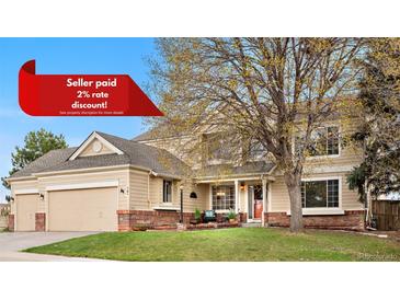 Charming two-story home with manicured lawn, mature tree, and inviting front porch at 5090 Golden Valley Trl, Castle Rock, CO 80109