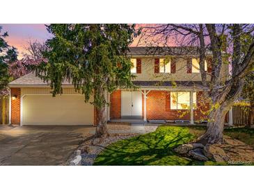 Charming two-story home with brick accents, mature trees, and a well-manicured lawn at 5556 S Sedalia St, Centennial, CO 80015