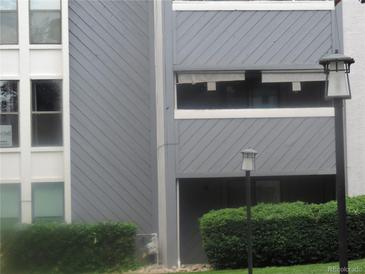 The apartment building with gray siding and trimmed bushes at 9887 E Peakview Ave # F06, Englewood, CO 80111