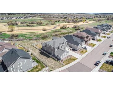 Stunning two-story home with neutral siding, attached garages, and well-maintained landscaping at 5736 Cadara Way, Parker, CO 80134