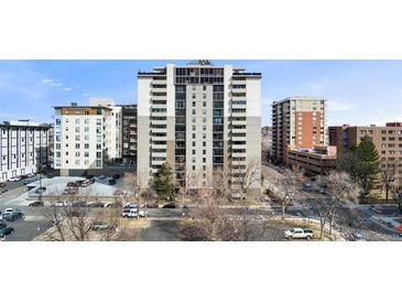 View of the high-rise building with ample parking and street access on a sunny day at 2 Adams St # 608, Denver, CO 80206