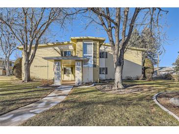 Inviting exterior view of a home with mature trees and a well-manicured lawn on a sunny day at 735 S Clinton St # 5B, Denver, CO 80247