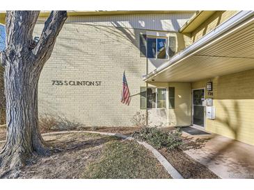 Charming home featuring classic architecture, decorative shutters, and an American flag at 735 S Clinton St # 5B, Denver, CO 80247