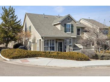 Charming two-story home with beautiful landscaping, front porch, and well-maintained lawn at 9431 Crossland Way, Highlands Ranch, CO 80130