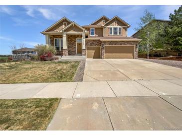 Charming two-story home boasts stone accents, a three-car garage, and well-maintained landscaping at 23559 Branston Ln, Parker, CO 80138