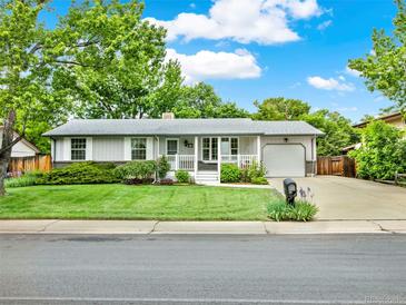 Charming single-story home featuring a well-manicured lawn and attached one car garage at 6943 Ingalls St, Arvada, CO 80003