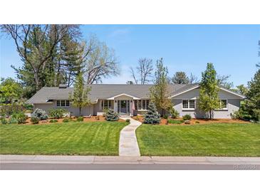 Charming single story home with a tidy lawn, mature trees, and a welcoming walkway to the front door at 21 Fairway Ln, Littleton, CO 80123