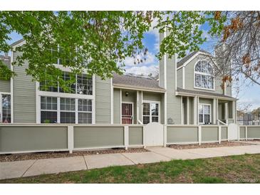 Charming townhome with large windows and a well-maintained front exterior at 5875 W Asbury Pl, Lakewood, CO 80227