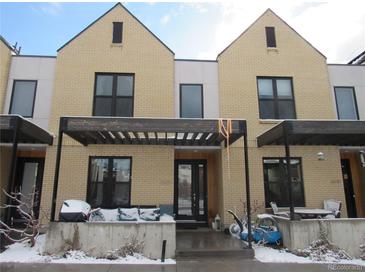 Inviting townhouse exterior with a pergola-covered porch and contemporary architectural details at 6850 E Archer Dr, Denver, CO 80230