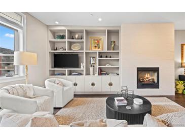 Inviting living room with built-in shelving, modern fireplace, and comfortable seating at 2826 Broadway St # 106, Boulder, CO 80304