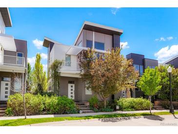 Stunning modern home featuring a two-story design, balcony, professional landscaping, and neutral color palette at 8774 Martin Luther King Blvd, Denver, CO 80238