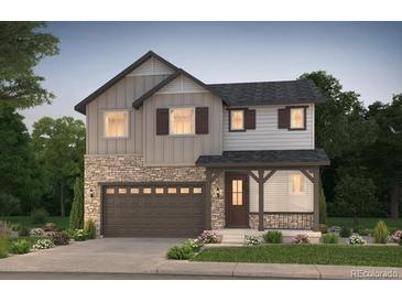 Charming two-story home featuring a stone facade, gray siding and a two-car garage at 2184 S Ider Way, Aurora, CO 80018