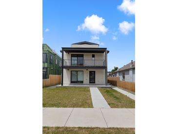 Modern two-story home featuring a white brick facade, balconies, and a well-maintained lawn at 3711 Pecos St, Denver, CO 80211