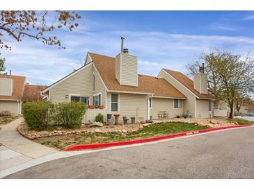 Charming home featuring a well-maintained yard with mature trees and manicured landscaping at 2485 S Xanadu Way # D, Aurora, CO 80014