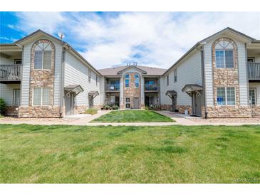 Charming condo building featuring beautiful stone accents and manicured lawn in a desirable community at 3250 E 103Rd Pl # 805, Thornton, CO 80229