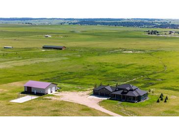Expansive property with a modern home, large garage, and plentiful land at 26100 County Road 5, Elizabeth, CO 80107