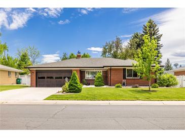 Charming brick ranch-style home featuring a well-manicured lawn, a two-car garage, and mature trees at 428 W Valleyview Ave, Littleton, CO 80120