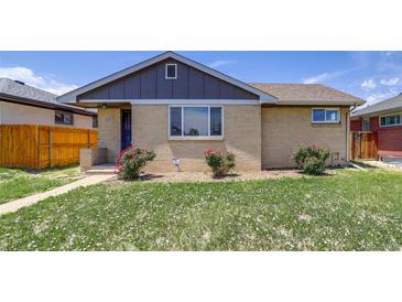 Charming home featuring a well-kept lawn and a classic brick facade at 3685 Jasmine St, Denver, CO 80207